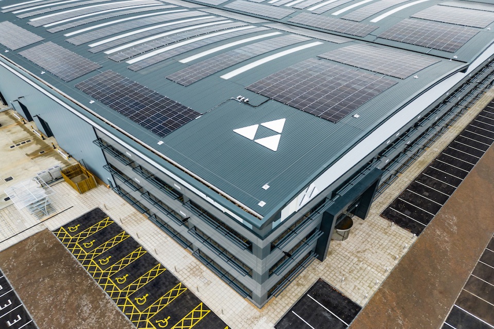 Overhead view of the roofs of Tritax Symmetry warehouses with solar panels and company logo