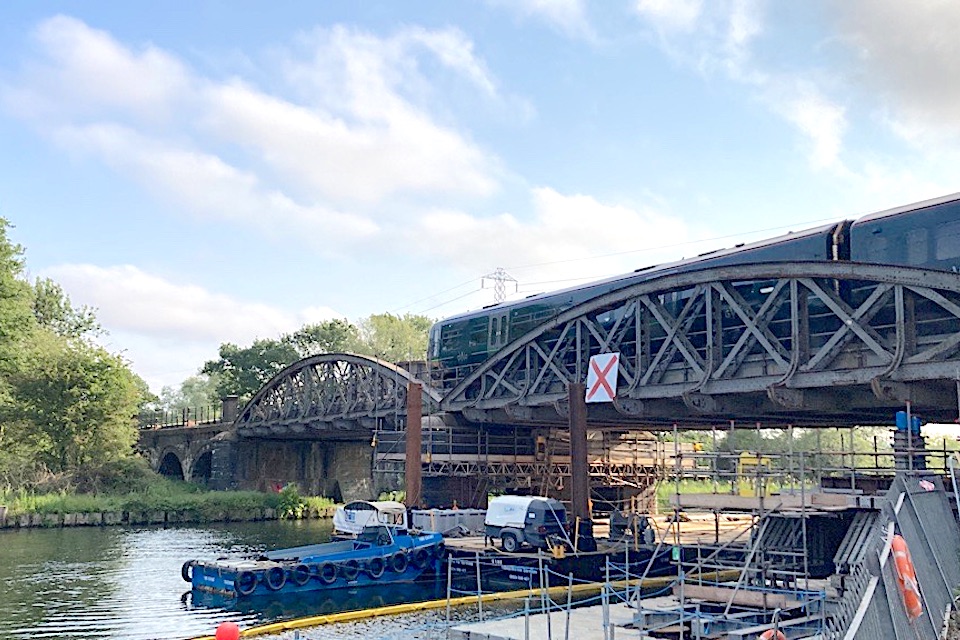First train crosses the rebuilt Nuneham Viaduct over the River Thames in Oxfordshire